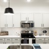 Apartment Kitchens With Modern Lighting And Stainless Steel Appliances At Abacus Alamo Ranch